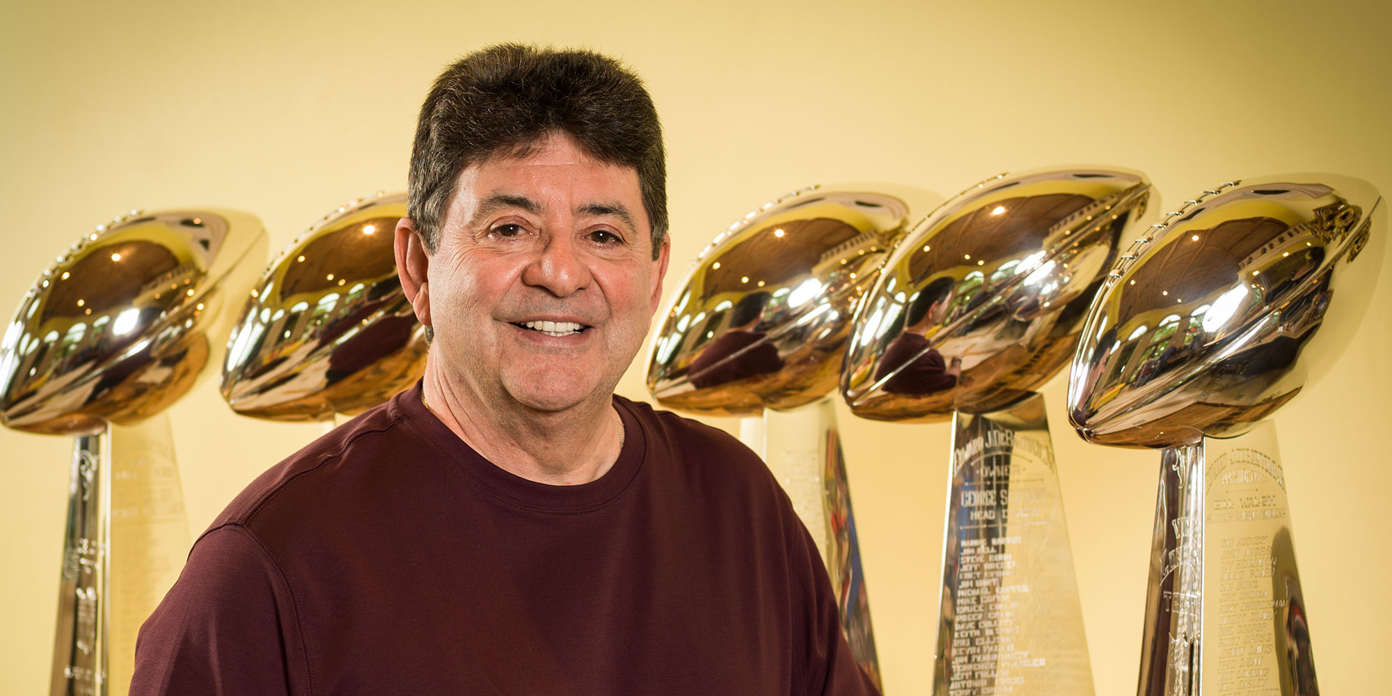 Tampa resident and San Fancisco 49's Hall of Fame Owner, Eddie Debartolo Jr. Posing in his trophy room with his five Lombardi Trophy's, awarded to the Super Bowl Champion.