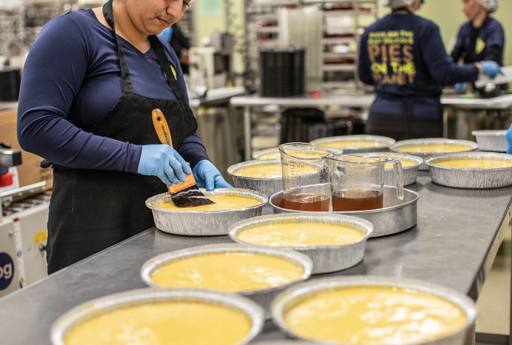 Image of working coating pies with honey 