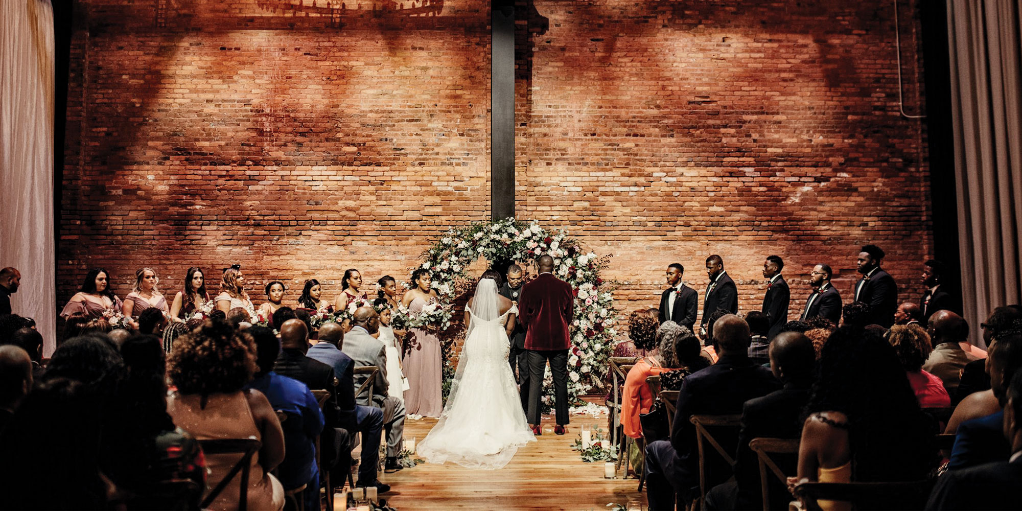 A wedding ceremony at Armature Works is staged in front of the building’s photogenic brick wall. Photo courtesy of Armature Works
