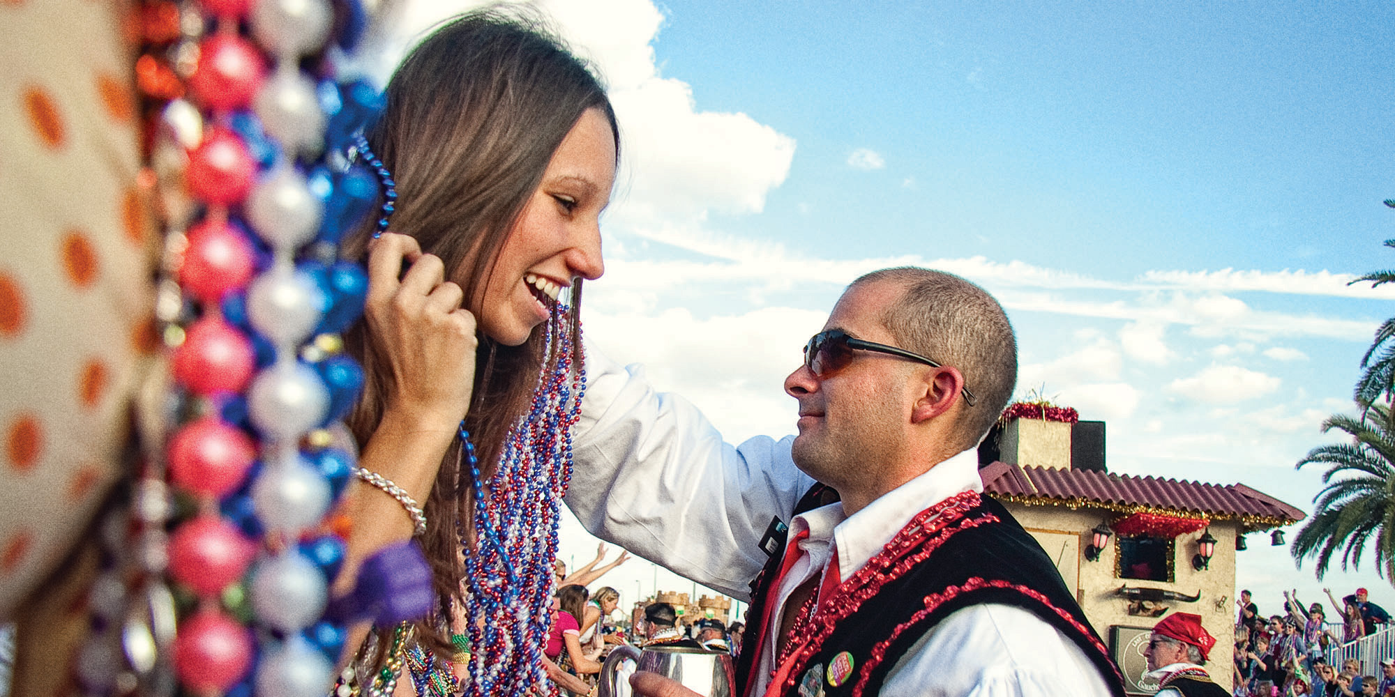A member of the Gaucho Association of Tampa hands out beads during Gasparilla.