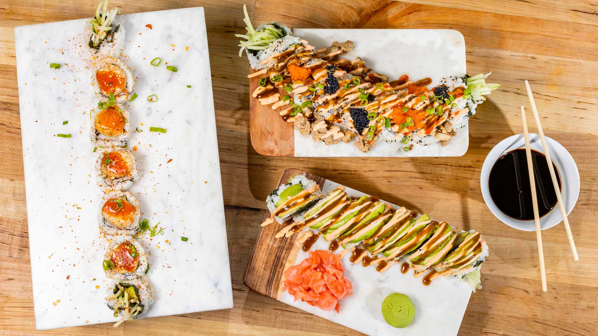 Three of house of Vegano's signature rolls, The Royale Roll (left), The Volcano Roll (top right) and the Caterpillar Roll (bottom right) (Photography by Gabriel Burgos)