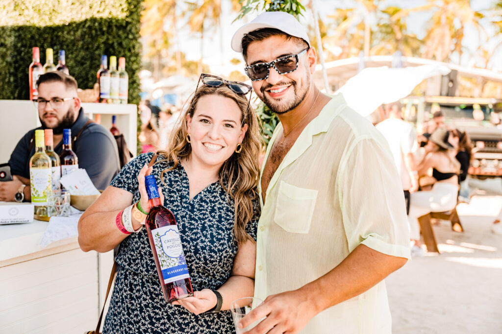 Woman and man holding a bottle of Castello del Poggio's Blueberry Bliss wine